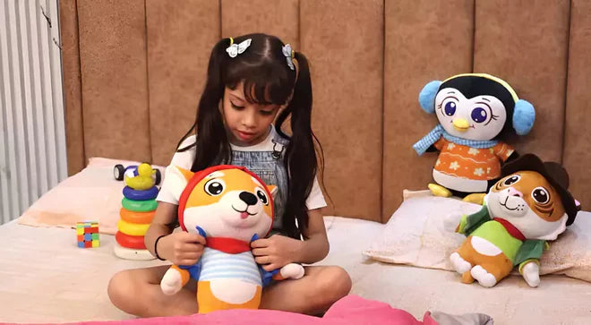 Child playing with a dog plush toy on a bed with penguin and tiger toys around