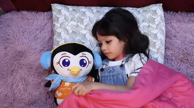 Child sleeping on a bed with a penguin plush toy, surrounded by pink and purple bedding.