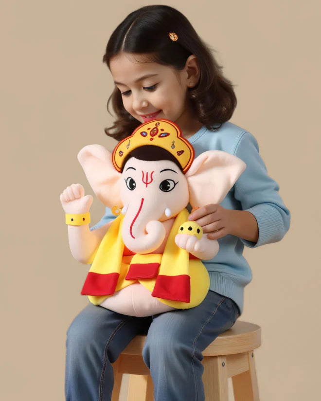 Child holding a aurbo mantra chanting ganesha soft toy with a plain background