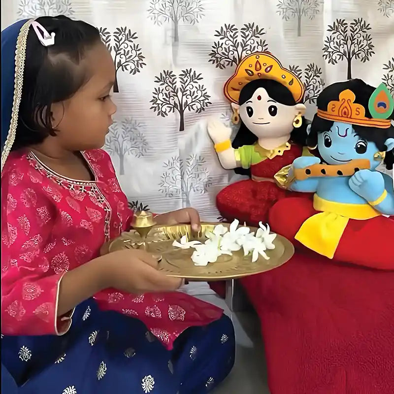 little girl with aurbo mantra chanting baby lakshmi & krishna plush toy