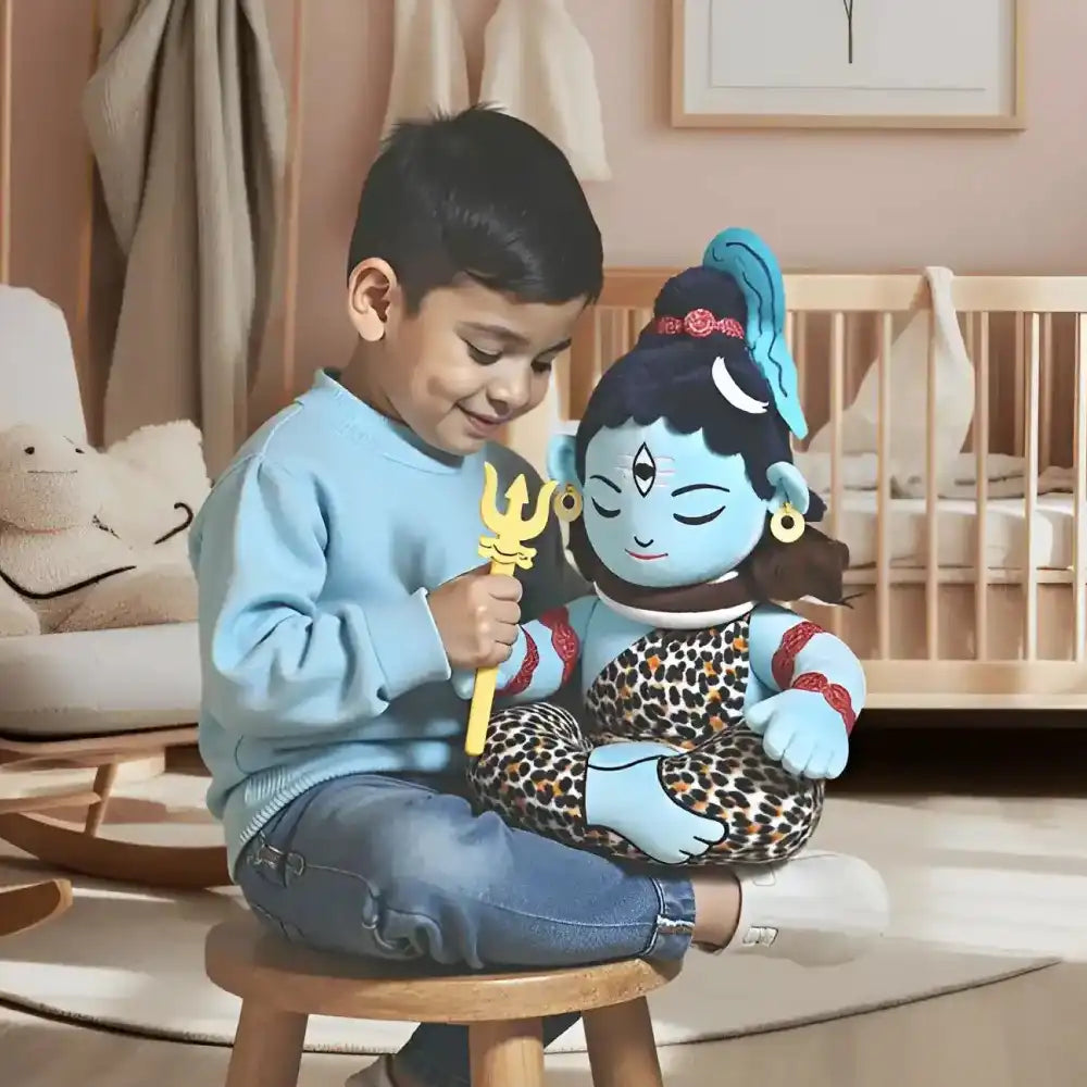 little boy with aurbo mantra chanting baby shiva plush toy
