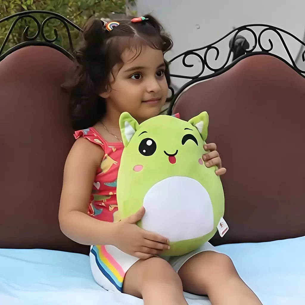 a little gild sitting holding aurbo green plush pillow soft toy